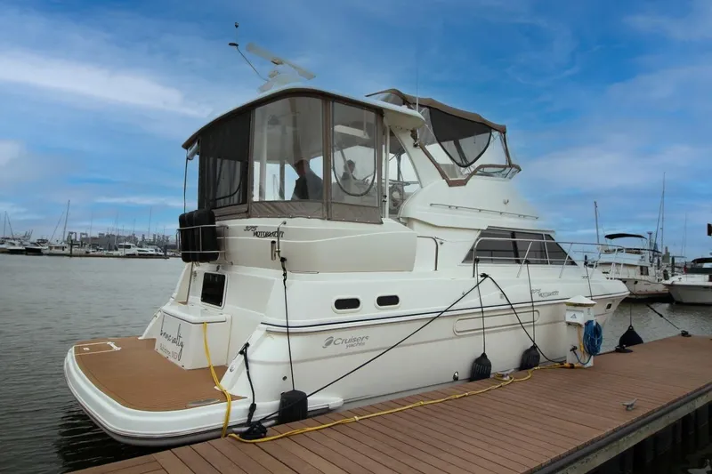 Slide: The Image of 2005 Cruisers Yachts 375 Motoryacht docked at marina under blue sky. - 2