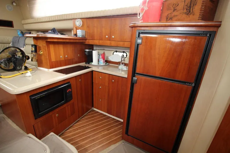 Slide: The Image of 2005 Cruisers Yachts 375 Motoryacht kitchen with wood cabinetry and modern appliances. - 22