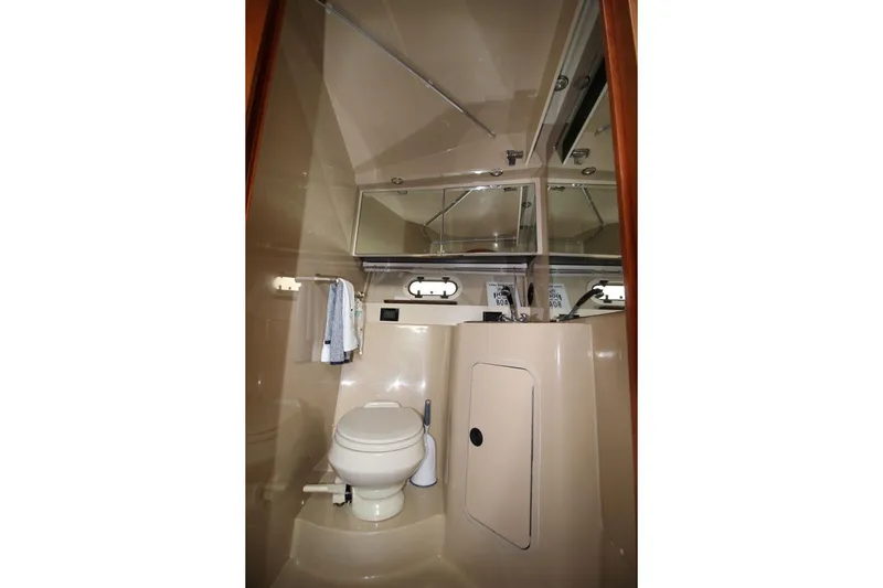 Slide: The Image of Bathroom interior of 2005 Cruisers Yachts 375 Motoryacht, featuring toilet and mirror. - 23