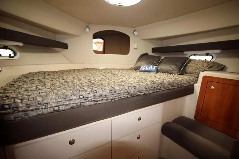 Slide: The Image of 2005 Cruisers Yachts 375 Motoryacht cabin with cozy bed and storage drawers. - 24