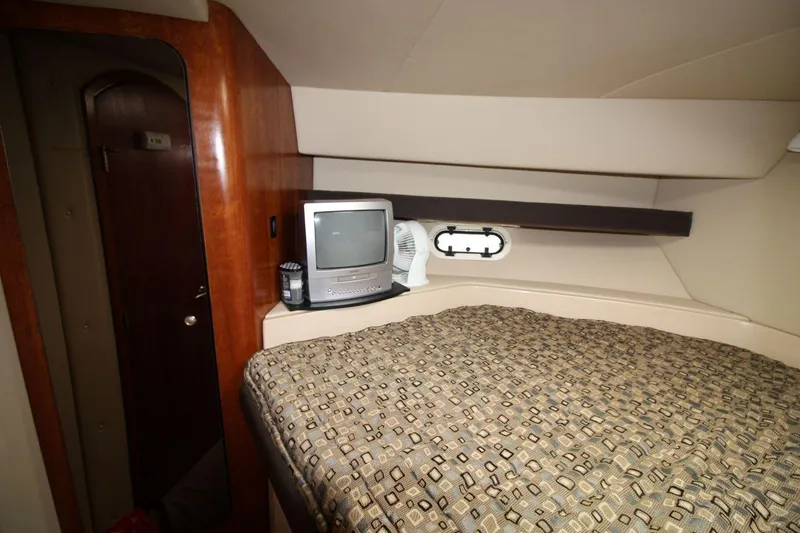 Slide: The Image of 2005 Cruisers Yachts 375 Motoryacht cabin with bed, TV, and porthole window. - 25