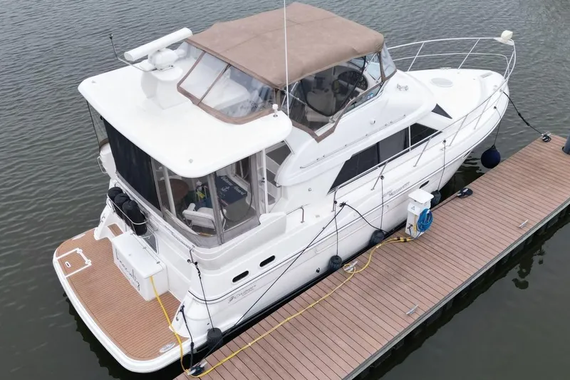 Slide: The Image of 2005 Cruisers Yachts 375 Motoryacht docked on calm water. - 4