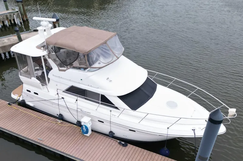 Slide: The Image of 2005 Cruisers Yachts 375 Motoryacht docked at marina, featuring sleek design and covered cockpit. - 5