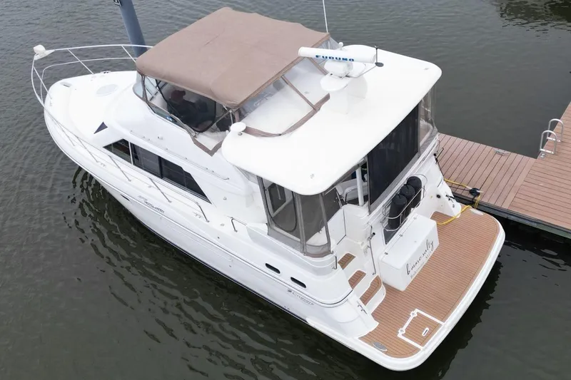 Slide: The Image of 2005 Cruisers Yachts 375 Motoryacht docked, featuring spacious deck and elegant design. - 7