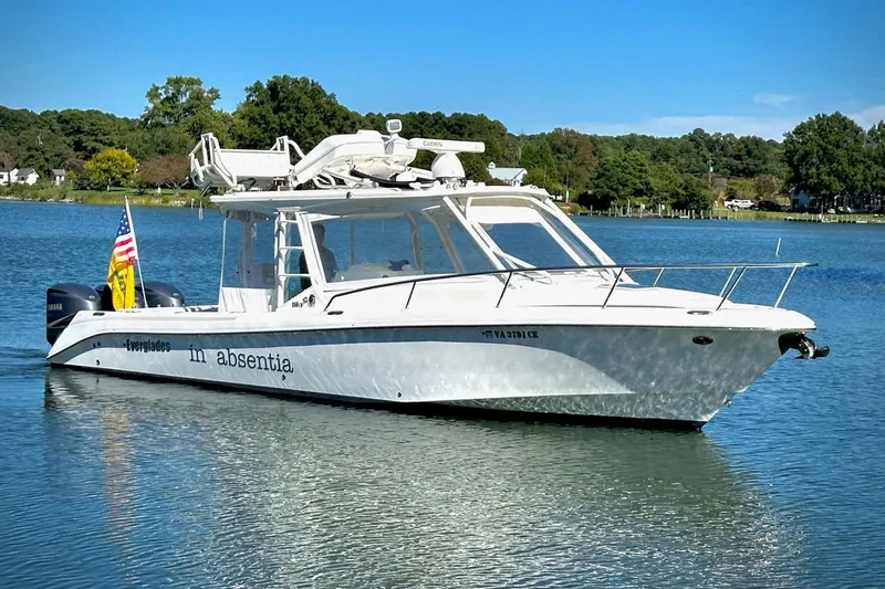 The Image of 2017 Everglades 350LX boat on a serene lake with clear blue skies. - 0