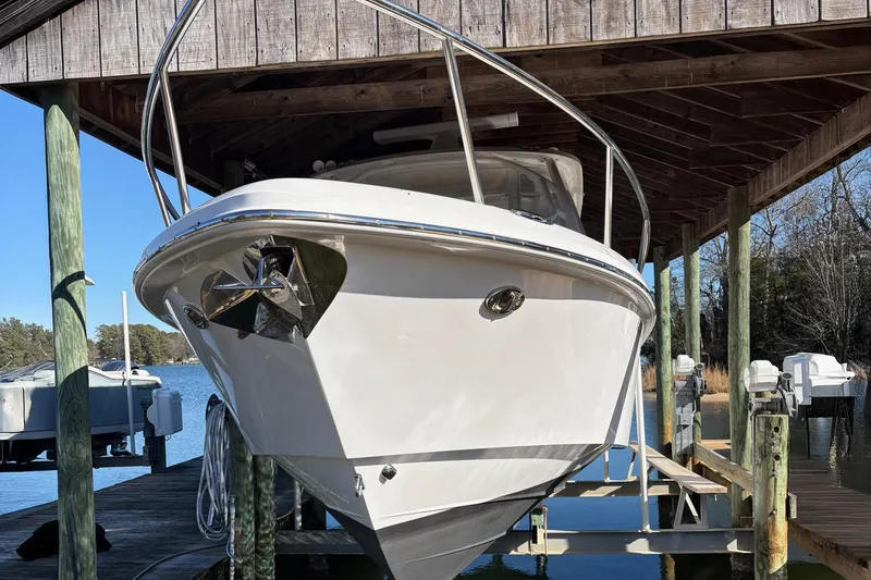 Slide: The Image of 2017 Everglades 350LX boat docked under wooden shelter by the water. - 14