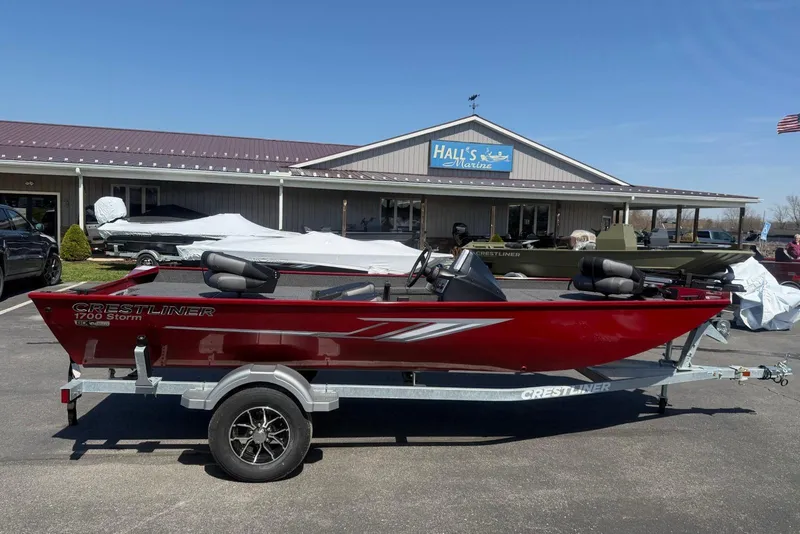 The Image of 2026 Crestliner 1700 Storm boat in red on trailer outside Hall's Marine. - 0