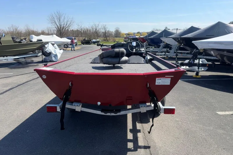Slide: The Image of 2026 Crestliner 1700 Storm boat in a parking lot, rear view, red exterior. - 2