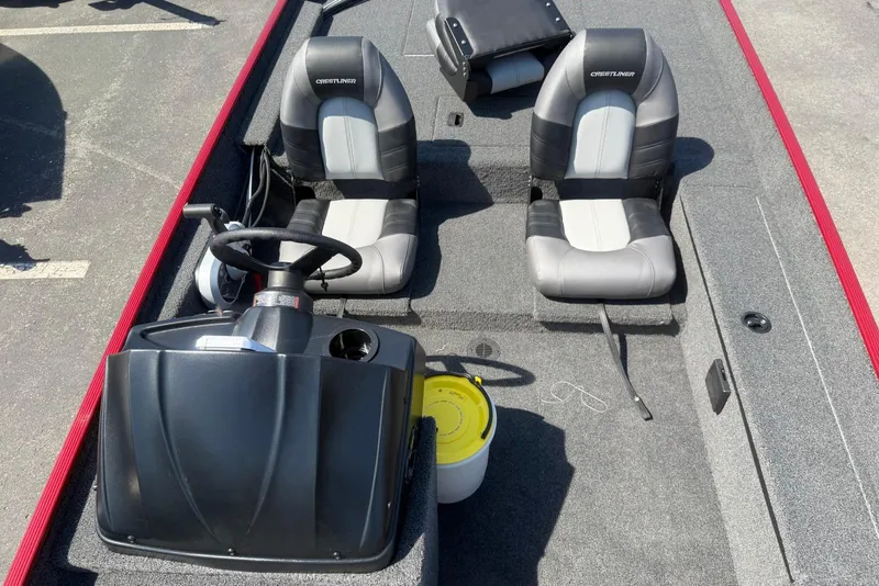 Slide: The Image of 2026 Crestliner 1700 Storm boat interior with dual seats and steering console. - 6
