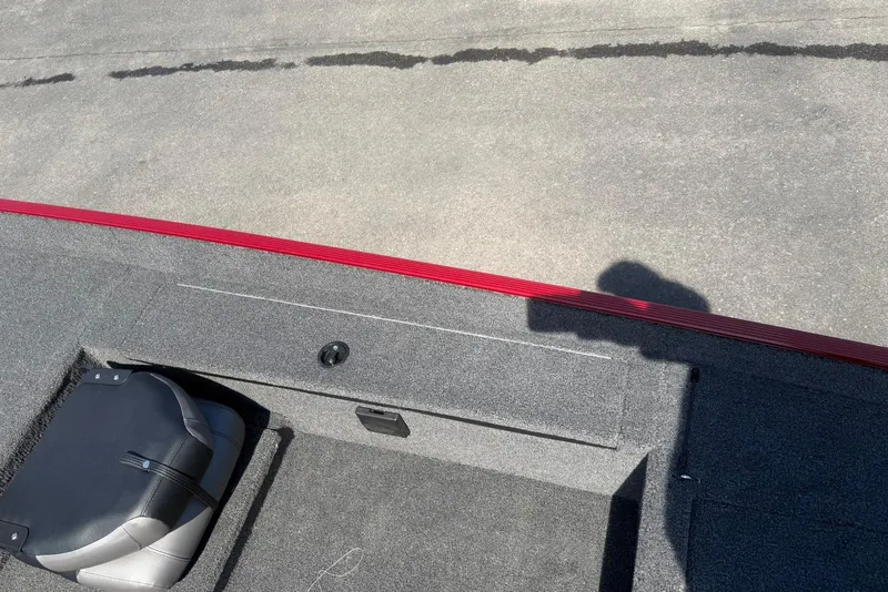 Slide: The Image of 2026 Crestliner 1700 Storm boat interior with gray carpet and red trim. - 7