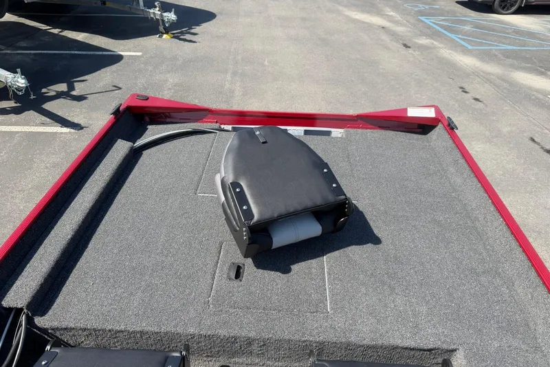 Slide: The Image of 2026 Crestliner 1700 Storm boat deck with folded seat, red trim, and gray carpet. - 8