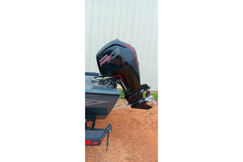 Slide: The Image of 2026 Ranger RT188C boat with Mercury Pro XS outboard motor, parked on gravel. - 12