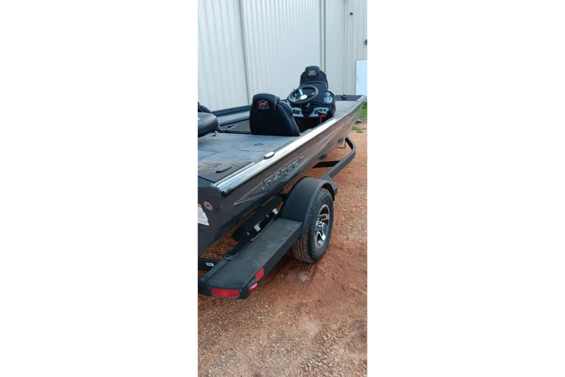 Slide: The Image of 2026 Ranger RT188C boat on trailer, parked on gravel near a building. - 18