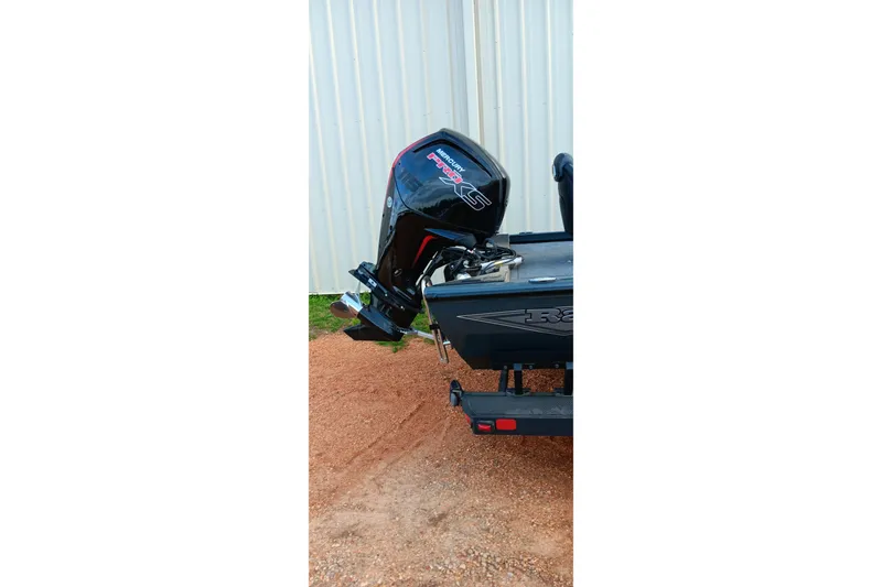 Slide: The Image of 2026 Ranger RT188C boat with Mercury Pro XS outboard motor, parked on gravel. - 20
