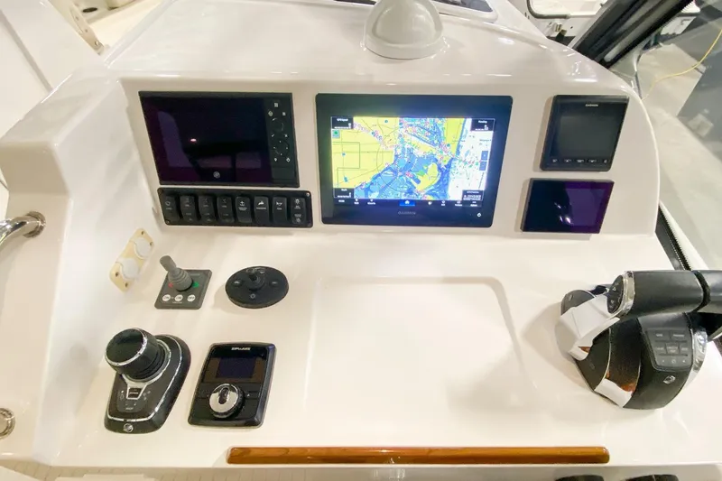 Slide: The Image of Control panel of 2022 MJM 3 boat featuring navigation screens and controls. - 48
