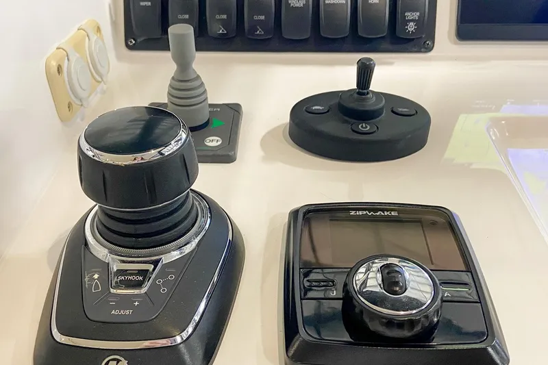 Slide: The Image of Control panel of a 2022 MJM 3 boat featuring joystick and Zipwake system. - 50