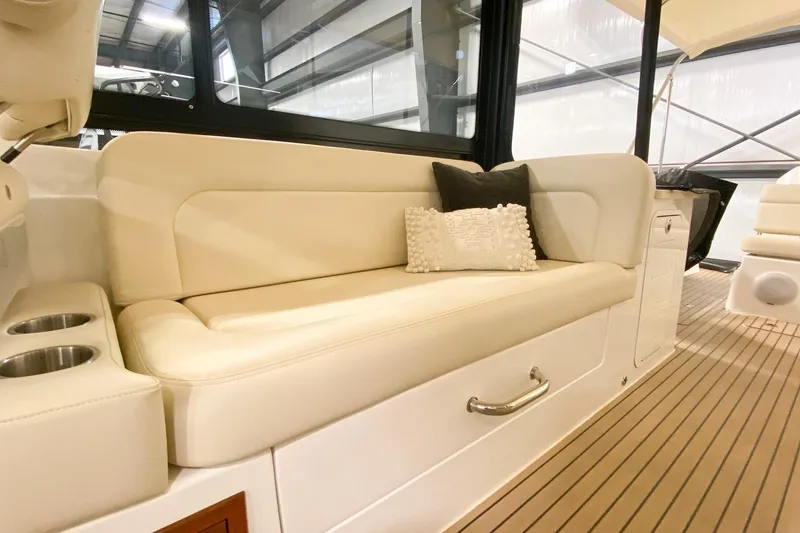 Slide: The Image of Luxurious seating area on a 2022 MJM 3 boat with plush cushions and cup holders. - 57