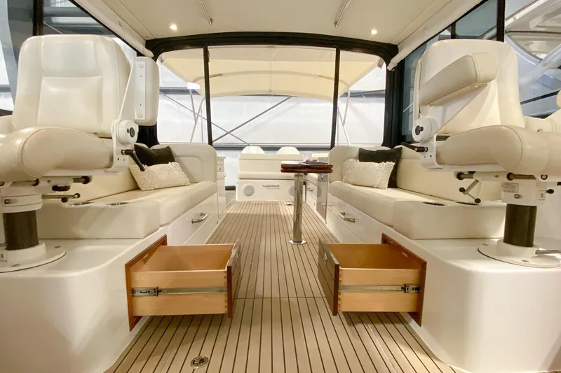 Slide: The Image of Luxurious interior of 2022 MJM 3 boat with plush seating and open storage drawers. - 59