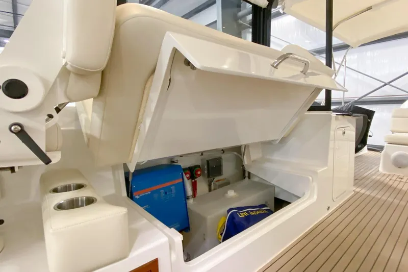 Slide: The Image of 2022 MJM 3 boat interior storage compartment with life jacket and equipment. - 62