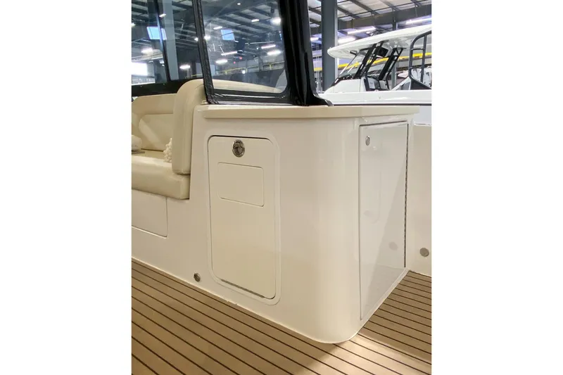 Slide: The Image of 2022 MJM 3 boat interior with sleek seating and wooden flooring. - 64