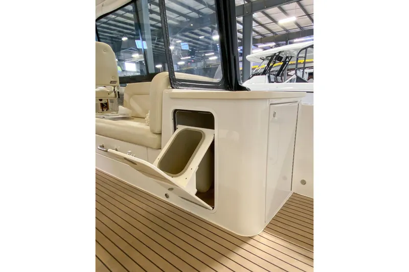 Slide: The Image of 2022 MJM 3 boat interior with open storage compartment and cushioned seating. - 65