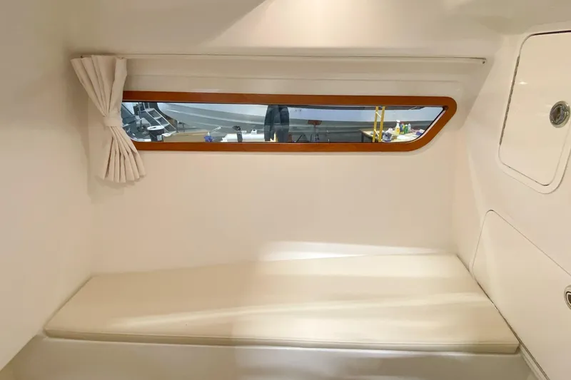 Slide: The Image of Interior cabin of 2022 MJM 3 boat with window and seating area. - 66