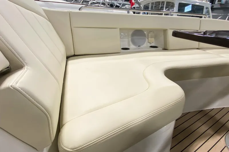 Slide: The Image of Luxurious seating on 2022 MJM 3 boat with cream upholstery and wooden accents. - 70