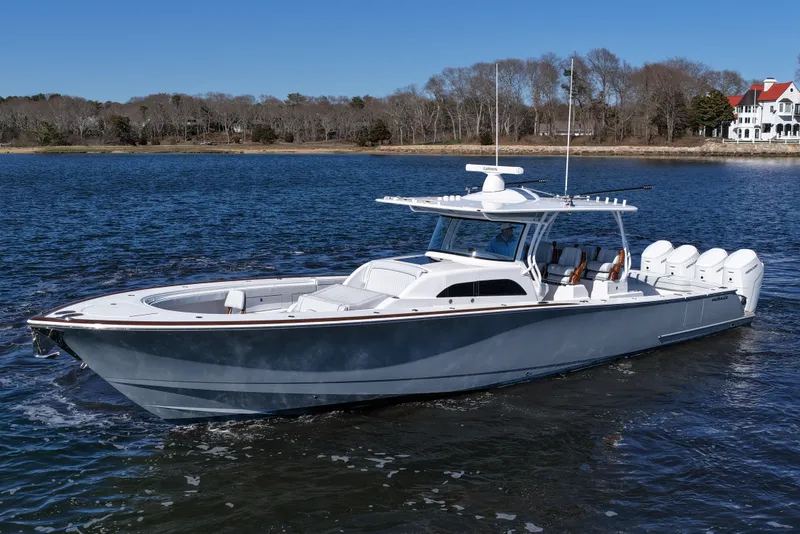 Slide: The Image of 2026 Valhalla Boatworks V-46 cruising on a serene lake with a scenic backdrop. - 13