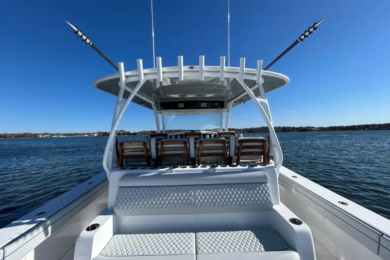 Slide: The Image of 2026 Valhalla Boatworks V-46 on water, showcasing seating and fishing rods. - 22