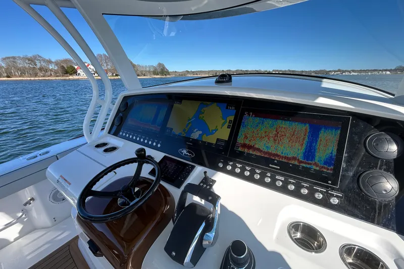 Slide: The Image of Helm of 2026 Valhalla Boatworks V-46 with advanced navigation displays on a sunny day. - 23