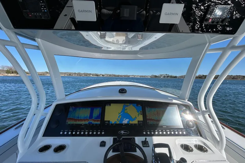 Slide: The Image of 2026 Valhalla Boatworks V-46 helm with Garmin navigation displays on open water. - 24