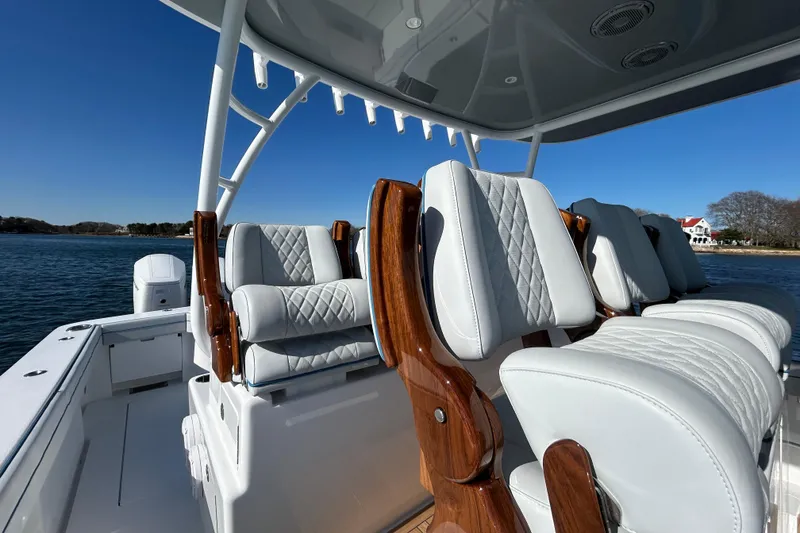 Slide: The Image of 2026 Valhalla Boatworks V-46 interior with luxurious white seating and wooden accents. - 29