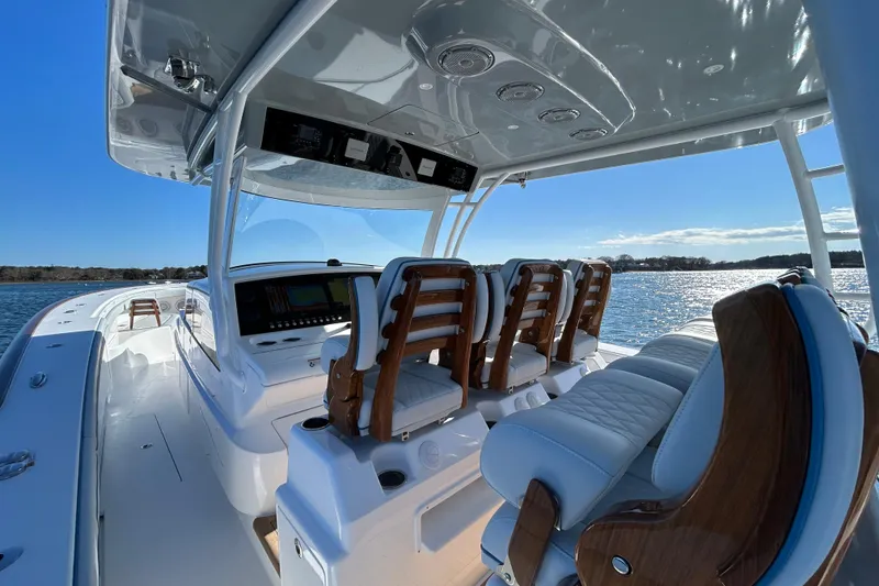 Slide: The Image of 2026 Valhalla Boatworks V-46 interior with luxurious seating and advanced controls on a sunny day. - 36