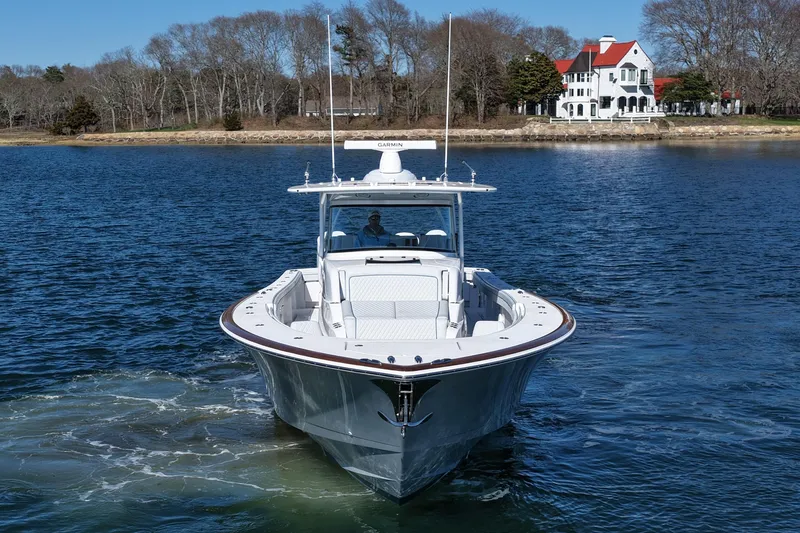 Slide: The Image of 2026 Valhalla Boatworks V-46 cruising on a serene lake near a picturesque house. - 4