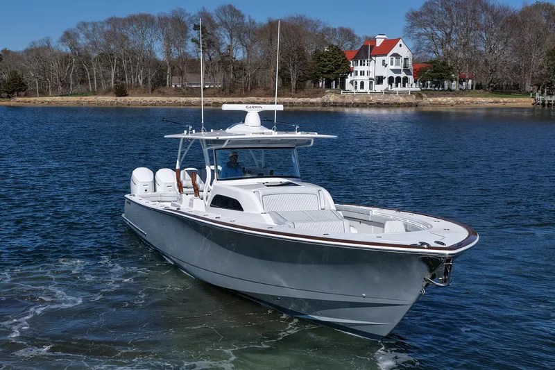 Slide: The Image of 2026 Valhalla Boatworks V-46 cruising on a serene lake near a picturesque house. - 5