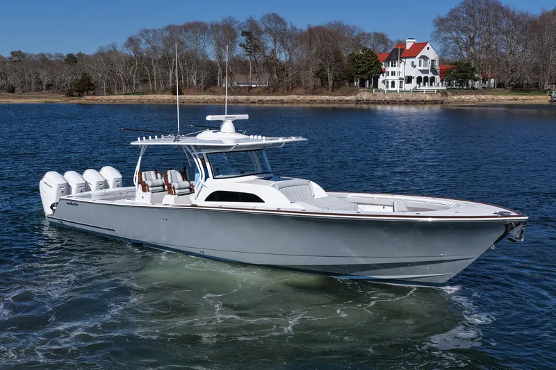 Slide: The Image of 2026 Valhalla Boatworks V-46 cruising on a serene lake near a picturesque house. - 6