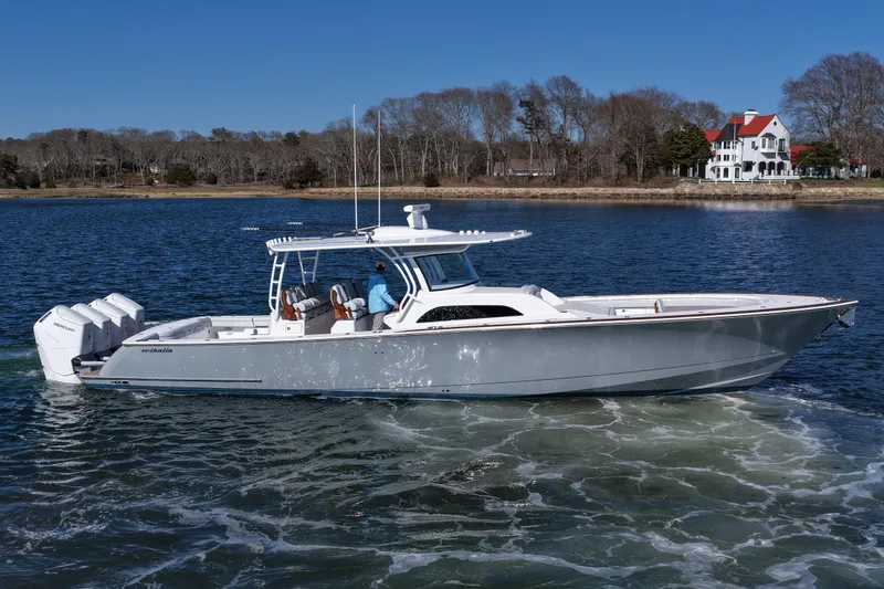 Slide: The Image of 2026 Valhalla Boatworks V-46 cruising on a serene lake with scenic background. - 7