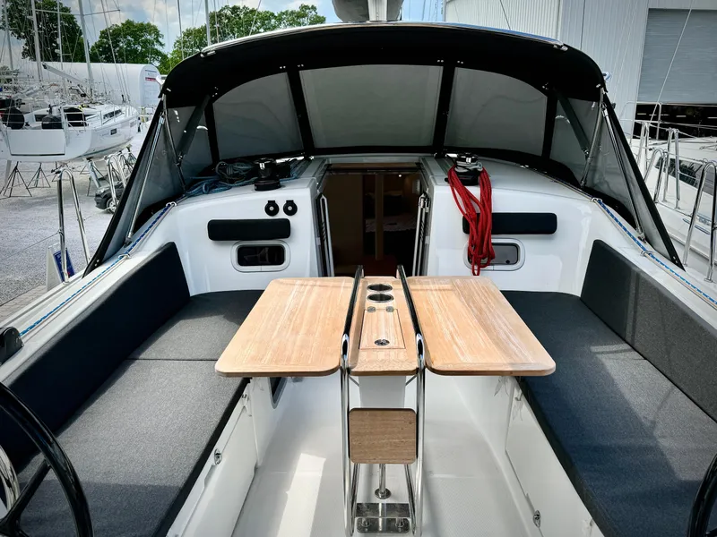Slide: The Image of Jeanneau Sun Odyssey 380 cockpit, 2023 model, featuring wooden table and seating. - 18