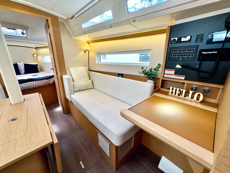 Slide: The Image of Interior of 2023 Jeanneau Sun Odyssey 380 yacht with cozy sofa and control panel. - 23