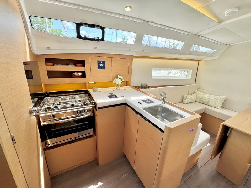 Slide: The Image of Interior of Jeanneau Sun Odyssey 380 yacht, modern kitchen and seating area. - 24