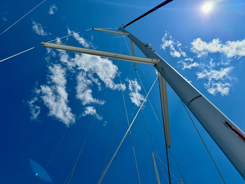 Slide: The Image of Mast of Jeanneau Sun Odyssey 380 sailboat, 2023, against blue sky. - 8