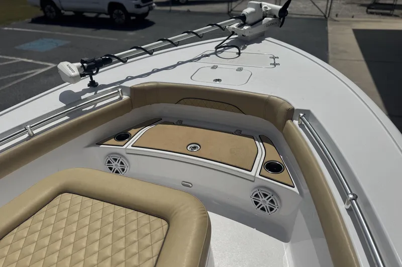 Slide: The Image of 2025 Sportsman Masters 247OE Bay Boat interior with tan seating and Garmin equipment. - 11