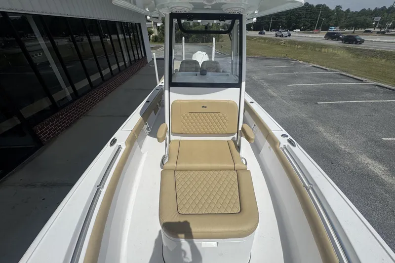 Slide: The Image of 2025 Sportsman Masters 247OE Bay Boat with tan seating, parked near a building. - 13