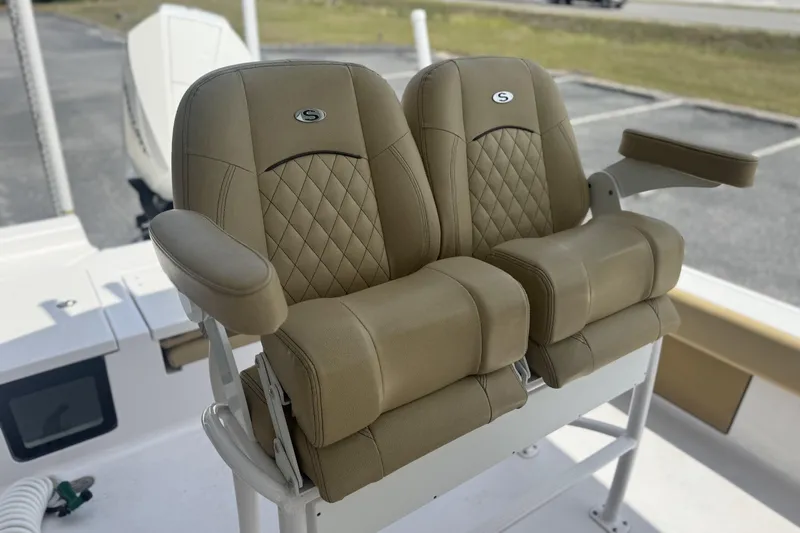 Slide: The Image of Luxurious seating on 2025 Sportsman Masters 247OE Bay Boat with tan upholstery and armrests. - 15