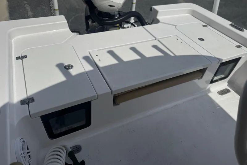 Slide: The Image of 2025 Sportsman Masters 247OE Bay Boat deck with storage compartments and coiled hose. - 16