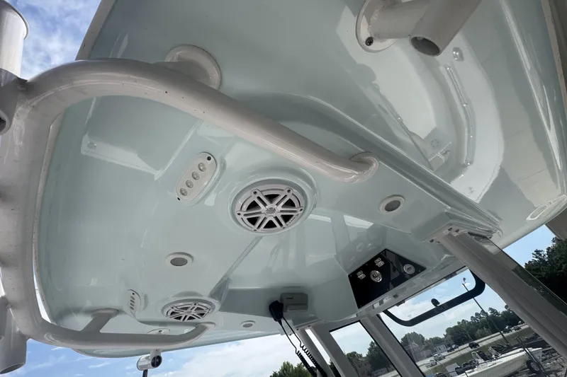 Slide: The Image of 2025 Sportsman Masters 247OE Bay Boat T-top with speakers and rod holders. - 23