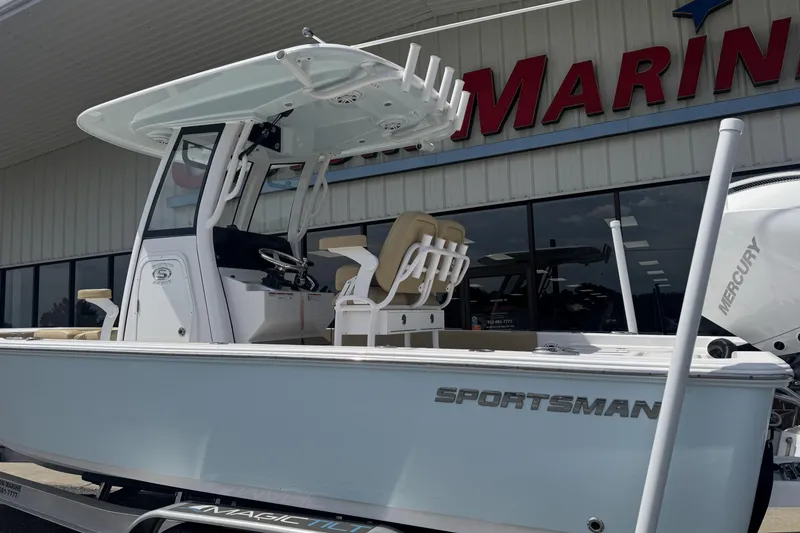 Slide: The Image of 2025 Sportsman Masters 247OE Bay Boat displayed outside a marine dealership. - 4