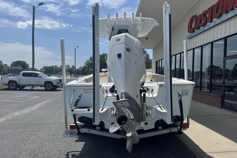 Slide: The Image of 2025 Sportsman Masters 247OE Bay Boat parked outside dealership, rear view. - 5