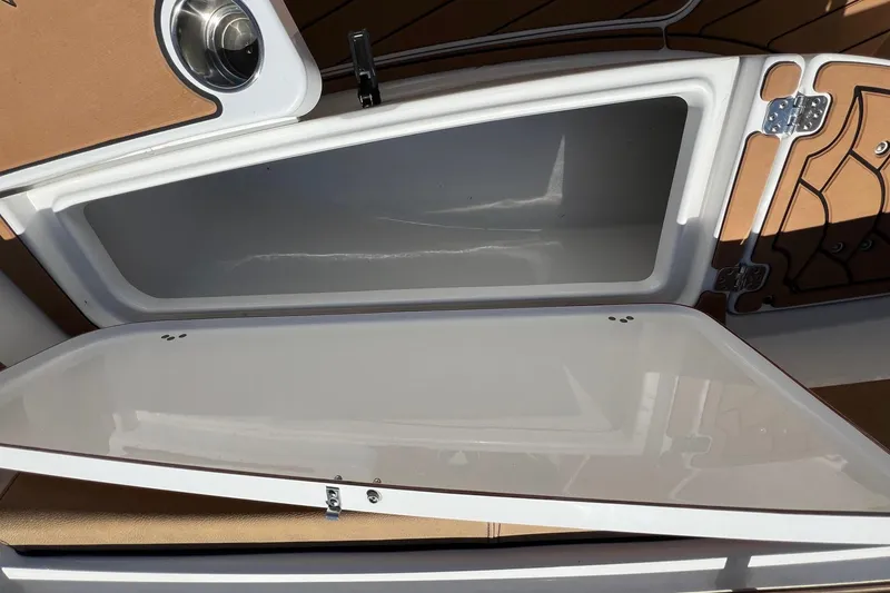 Slide: The Image of Open storage compartment on a 2021 Sea Pro 239 Center Console boat. - 14