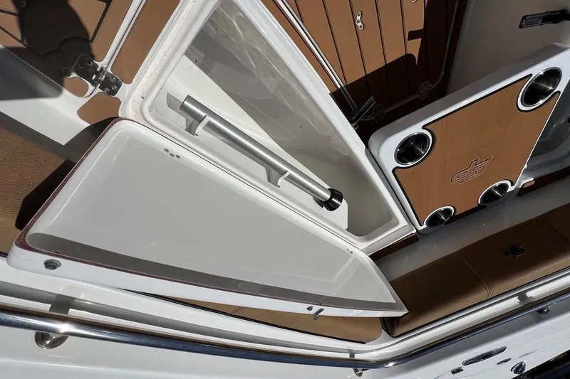 Slide: The Image of 2021 Sea Pro 239 Center Console boat interior with storage compartment and cup holders. - 15